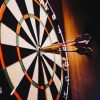 dart board with darts in the bullseye