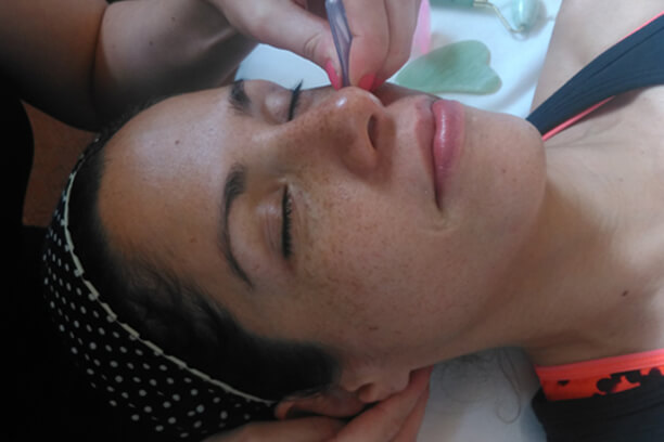 lady receiveing a relaxing face massage
